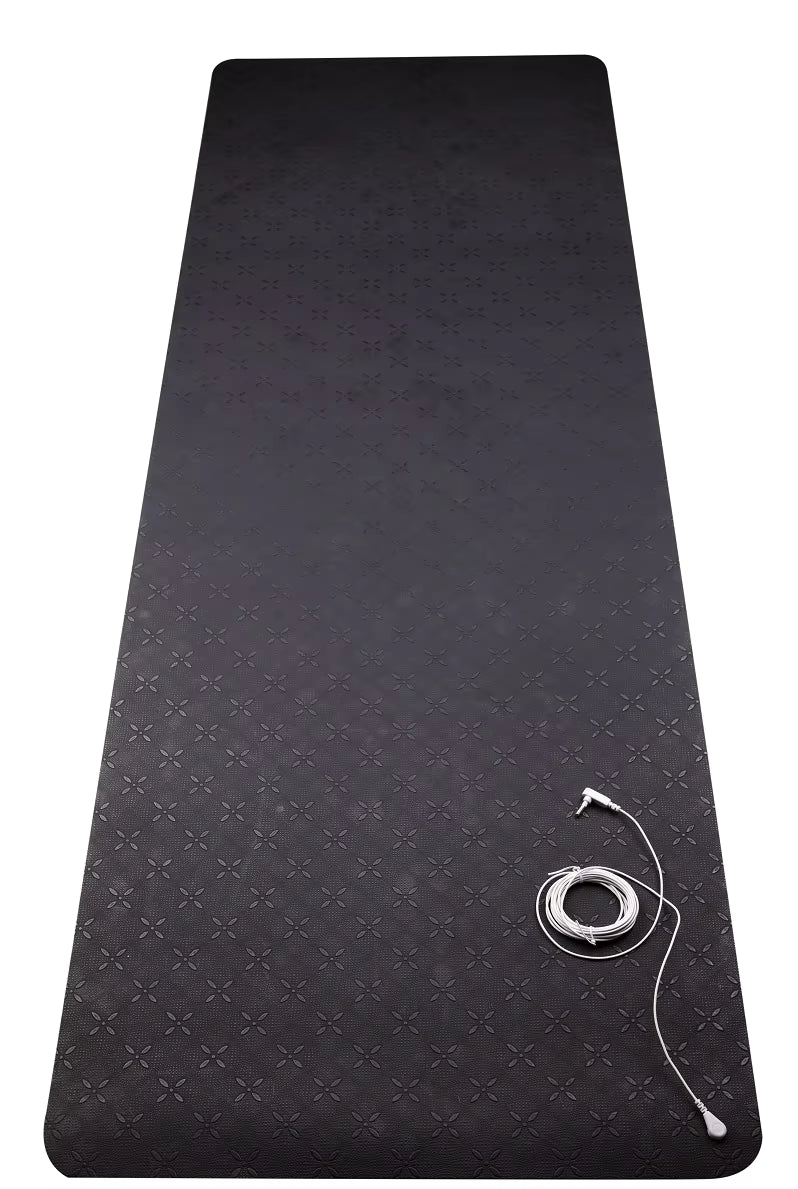 Black yoga mat with a strap on a white background