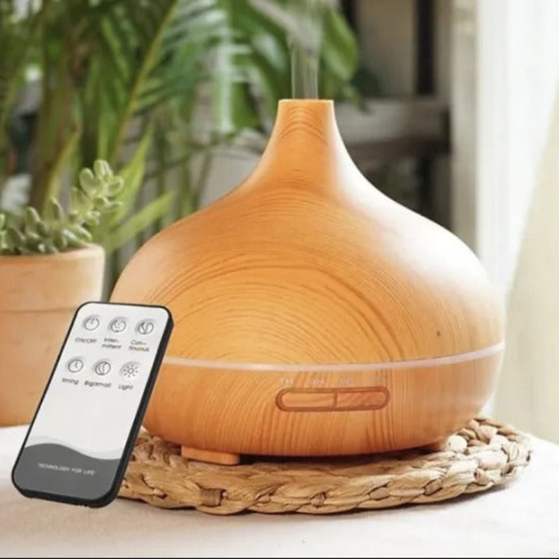 Wooden diffuser with remote control on a table with plants in the background