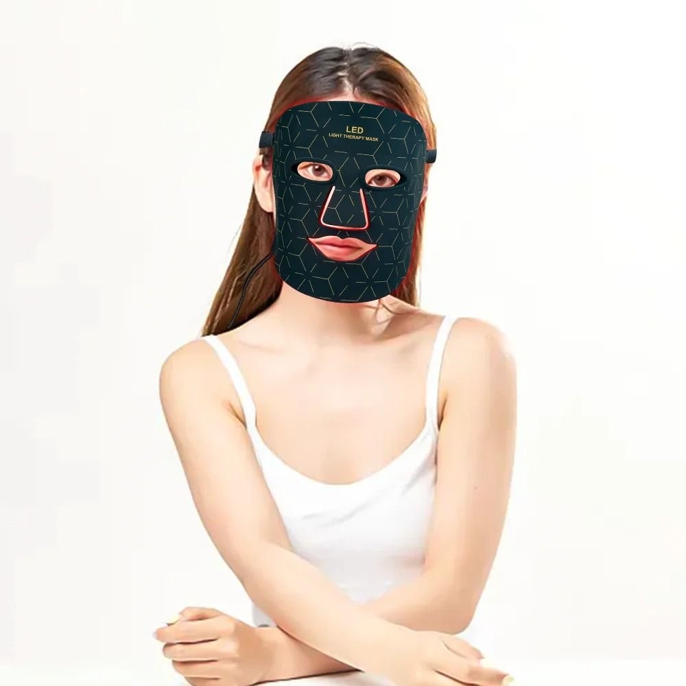 An LED light therapy face mask set shown with its black box, featuring a black mask